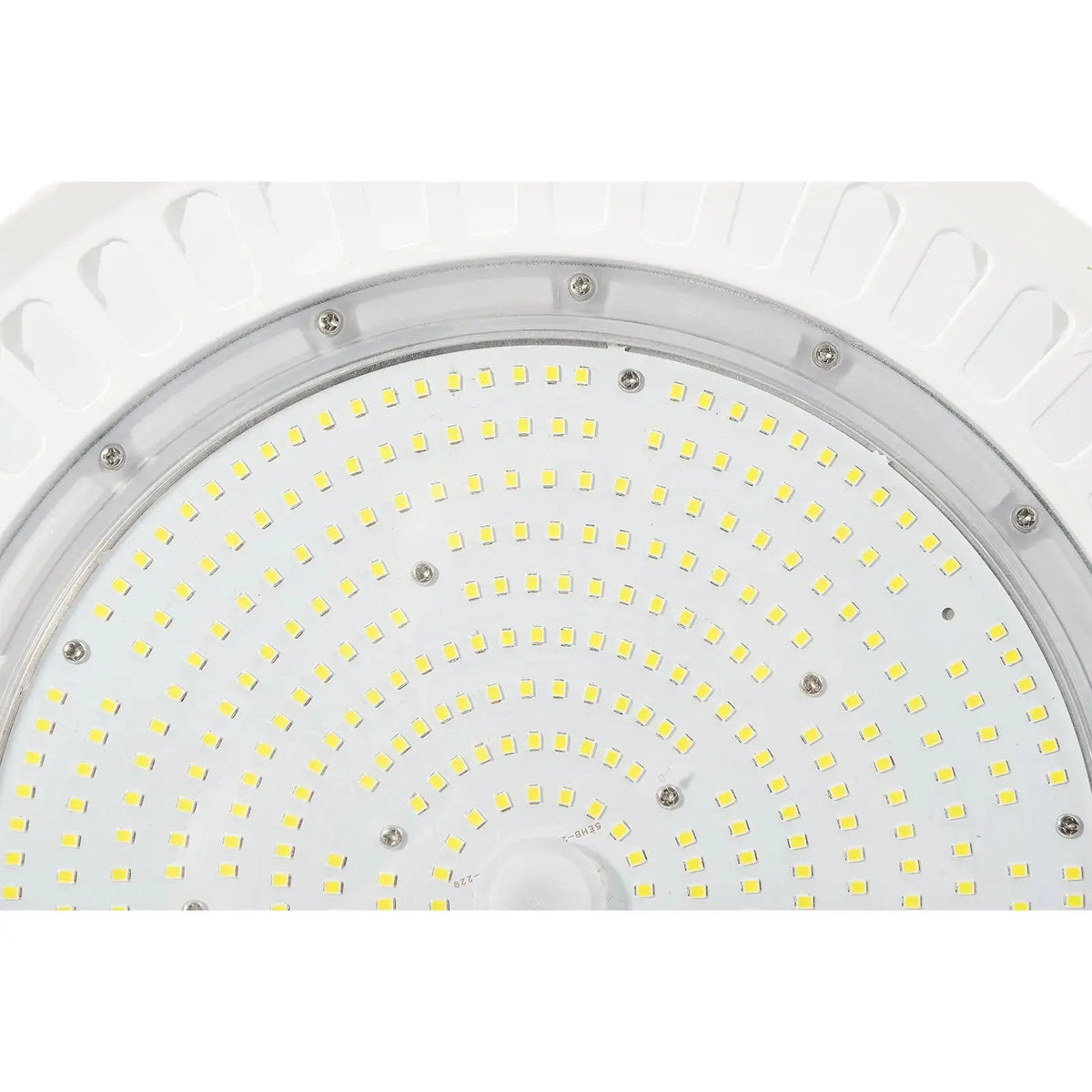 Close-up of the circular LED array and clear lens on a white UFO high bay light